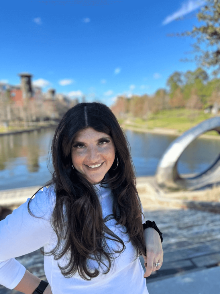 Rachel standing in front of a lake.