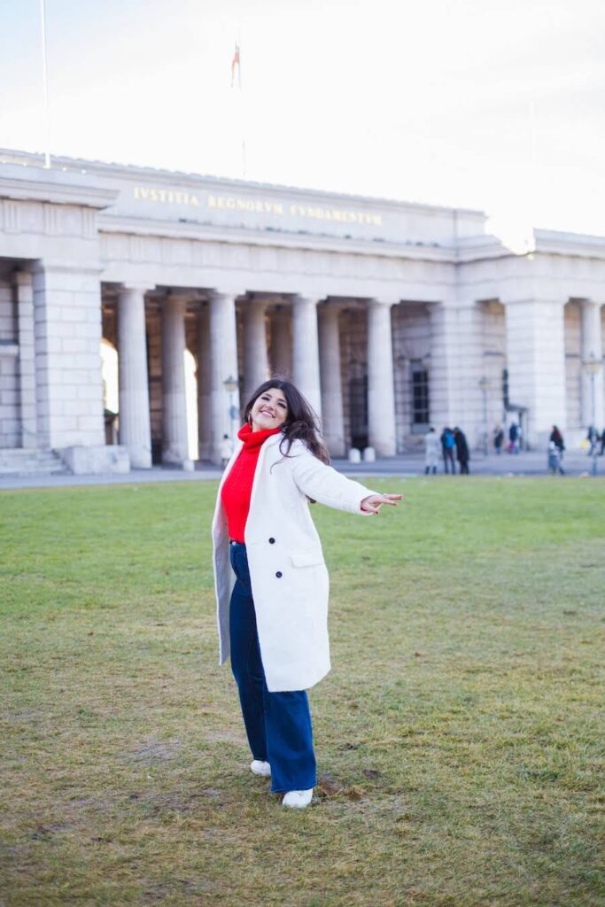 Rachel Rofé standing on the grass in Greece, a location she has traveled to often thanks to her print on demand business.
